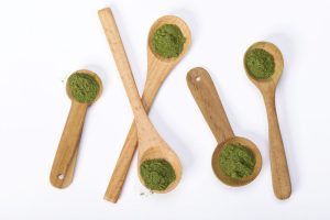 several spoons of kratom laid out on table