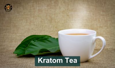 Kratom Tea with a My lucky buddha logo on top and kratom tea cup on the bottom next to a raw kratom leaf