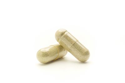 close up kratom capsules white background