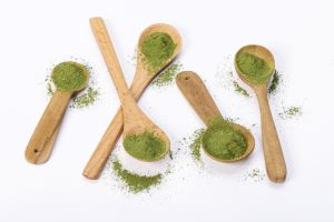 Different types of kratom powder on wooden spoons