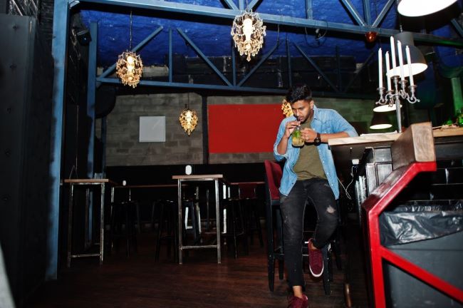 man drinking kava in kava bar