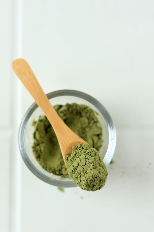 Kratom Powder on spoon over bowl