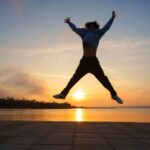 Energetic Man jumping in the sunset