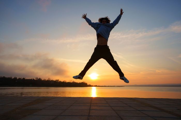 Energetic Man jumping in the sunset